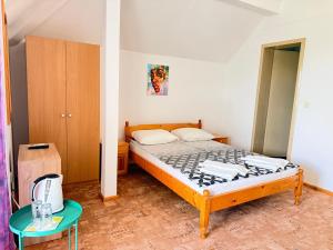 a small bedroom with a bed and a table at Guest House Orfey in Kranevo