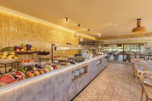 a restaurant with a buffet line with fruits and vegetables at Maspalomas Villas by Dunas - Adults Only in Maspalomas