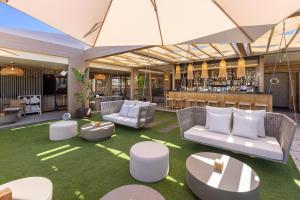 a lobby with white furniture and a bar at Maspalomas Villas by Dunas - Adults Only in Maspalomas