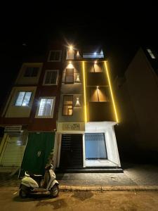 a scooter parked in front of a building at night at Spacious 2BHK Group Stay in Vijay Nagar, Indore in Indore +8 photos