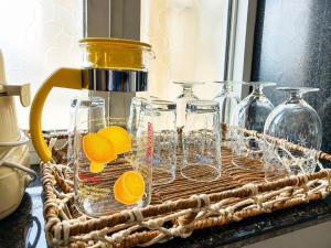 a wicker basket with glass jars and oranges in it at Sai Mahima Stays in Shirdi