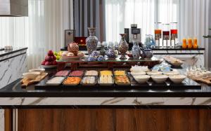 a buffet with many different types of food on a table at Farovon Khiva Hotel in Khiva