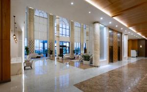 a lobby of a building with chairs and tables at Farovon Khiva Hotel in Khiva +93 photos