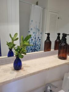 a bathroom counter with a blue vase sitting on a shelf at Posidonia -Son Bou Apartment in Son Bou