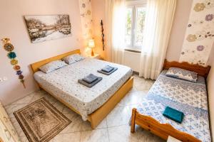 a bedroom with two beds and a window at Hill View 4 in Alexandroupoli