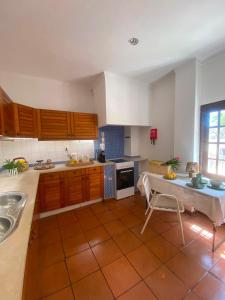a kitchen with a sink and a table in it at Casa Merino in Évora