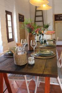 a wooden table with plates and wine glasses on it at Casa Merino in Évora +37 photos