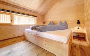 a bedroom with a bed in a wooden cabin at CASALPIN Chalets in Brand