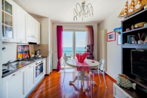 a kitchen with a table and a dining room at Mareincasa Dimora Luxury in Polignano a Mare