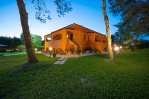 a house in a yard with two trees at Sole del Mediterraneo in Otranto