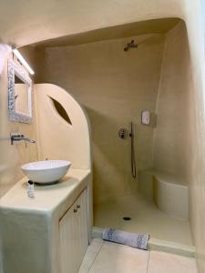 a bathroom with a sink and a shower at SantoCaves in Akrotiri +44 photos