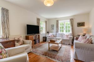 a living room with white furniture and a flat screen tv at 4 Bed in Lyndhurst oc-57407 in Lyndhurst