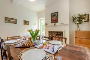 a dining room with a table and a fireplace at 4 Bed in Lyndhurst oc-57407 in Lyndhurst