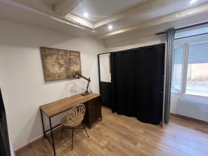 a room with a desk and a chair and a window at Appartement Limoges in Limoges
