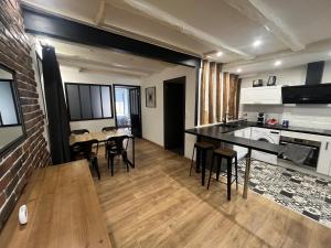 a kitchen and living room with a table and chairs at Appartement Limoges in Limoges