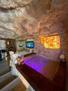 a large room with a pool in a cave at EmmejSuite in Pozzuoli