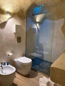 a bathroom with a shower and a toilet and a sink at EmmejSuite in Pozzuoli