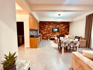 a living room with a table and a couch at Kristian apartments in Berat