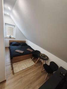 a small bedroom with a bed in a attic at Kontrabanda - Bar & Noclegi in Ustrzyki Górne +5 photos