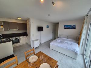 a small room with a bed and a table at Alpine Bliss Studio in Wilderswil