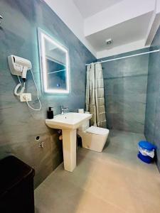 a bathroom with a sink and a toilet at Kristian apartments in Berat +42 photos