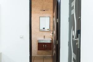a bathroom with a sink and a mirror at Hotel Ornate Residency And Suites in Gurgaon