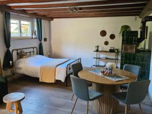 a bedroom with a bed and a table and chairs at la Parenthèse Kaysersberg in Kaysersberg