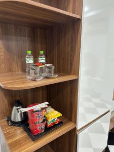 a cupboard with some food and drinks on it at Sen Hotel My Dinh Song Da 미딩 in Hanoi