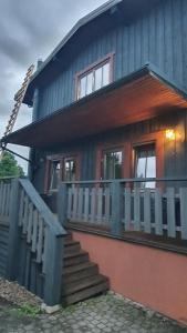 a house with a staircase in front of it at Ežerėlių sodyba in Ažuluokesa