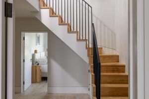 a staircase in a home with white walls and wooden floors at Brennik House in Port Isaac +32 photos