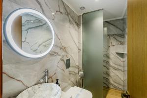 a bathroom with a sink and a mirror at Filoxenia Hotel Monemvasia in Monemvasia +66 photos