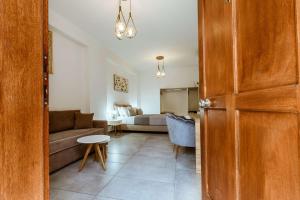 a living room with a couch and a bed at Deluxe Rooms in Chania