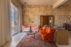 a living room with a couch and a table at Wadi Sabarah Lodge in Abu Dabbab