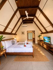 a bedroom with a large bed and a flat screen tv at DZION Resort Coorg in Gonikoppal +69 photos