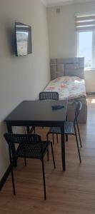 a table and chairs in a room with a bed at Eraj Bibi Fatima in Yamchin +5 photos