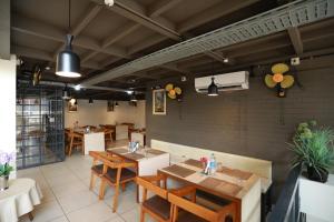 a restaurant with tables and chairs in a room at Aroma Ayur Heritage in Mattanūr