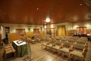 a conference room with chairs and a table and a podium at Aroma Ayur Heritage in Mattanūr