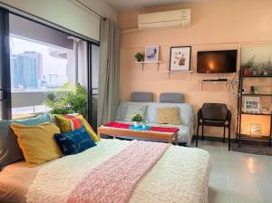 a bedroom with a bed and a large window at Cozy 1br walk to BTS and Airport Rail Link Close to Malls T in Bangkok