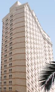 a tall building with many windows on the side of it at Wahet Al Deafah Hotel in Mecca