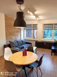 a living room with a table and a couch at Park Redena Katowice/Chorzów in Chorzów