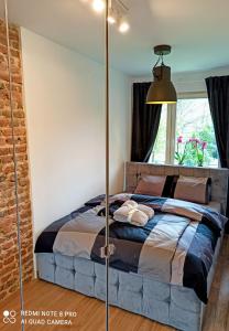 a bedroom with a bed and a window at Park Redena Katowice/Chorzów in Chorzów
