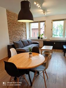 a living room with a table and a couch at Park Redena Katowice/Chorzów in Chorzów +20 photos