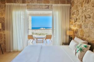 a bedroom with a bed and a view of the ocean at Wadi Sabarah Lodge in Abu Dabbab +66 photos