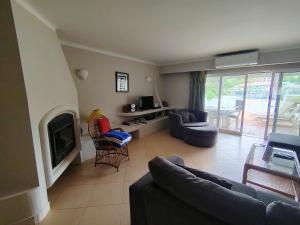 a living room with a couch and a tv at Vale Do Lobo 935 in Loulé