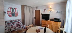 a living room with a couch and a table at Casse blanche in Orcières