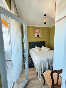 a bedroom with a bed and a sliding glass door at kobuleti Apartment in Kobuleti