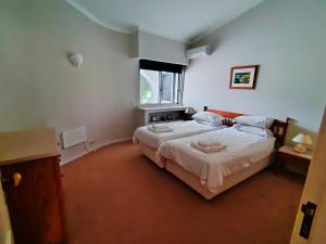 a bedroom with two beds and a window at Vale Do Lobo 935 in Loulé +18 photos