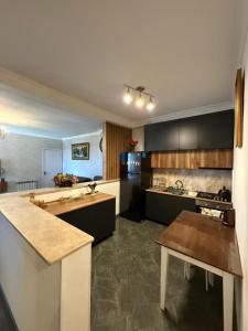 a large kitchen with black cabinets and a counter top at kobuleti Apartment in Kobuleti +9 photos
