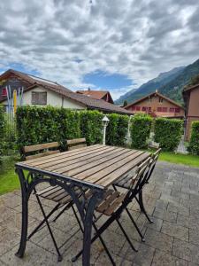 a wooden bench sitting on top of a patio at Alpine Bliss Studio in Wilderswil