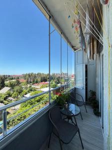 a balcony with chairs and a table with a view at kobuleti Apartment in Kobuleti